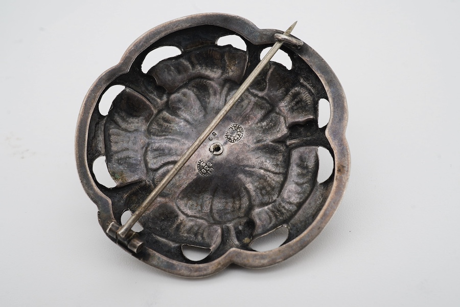 A Danish Georg Jensen sterling 925 and five stone cabochon garnet cluster set circular foliate brooch, design no. 59, 1915-1927 mark, diameter 47mm. Condition - fair to good